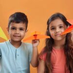 kids playing with paper plane