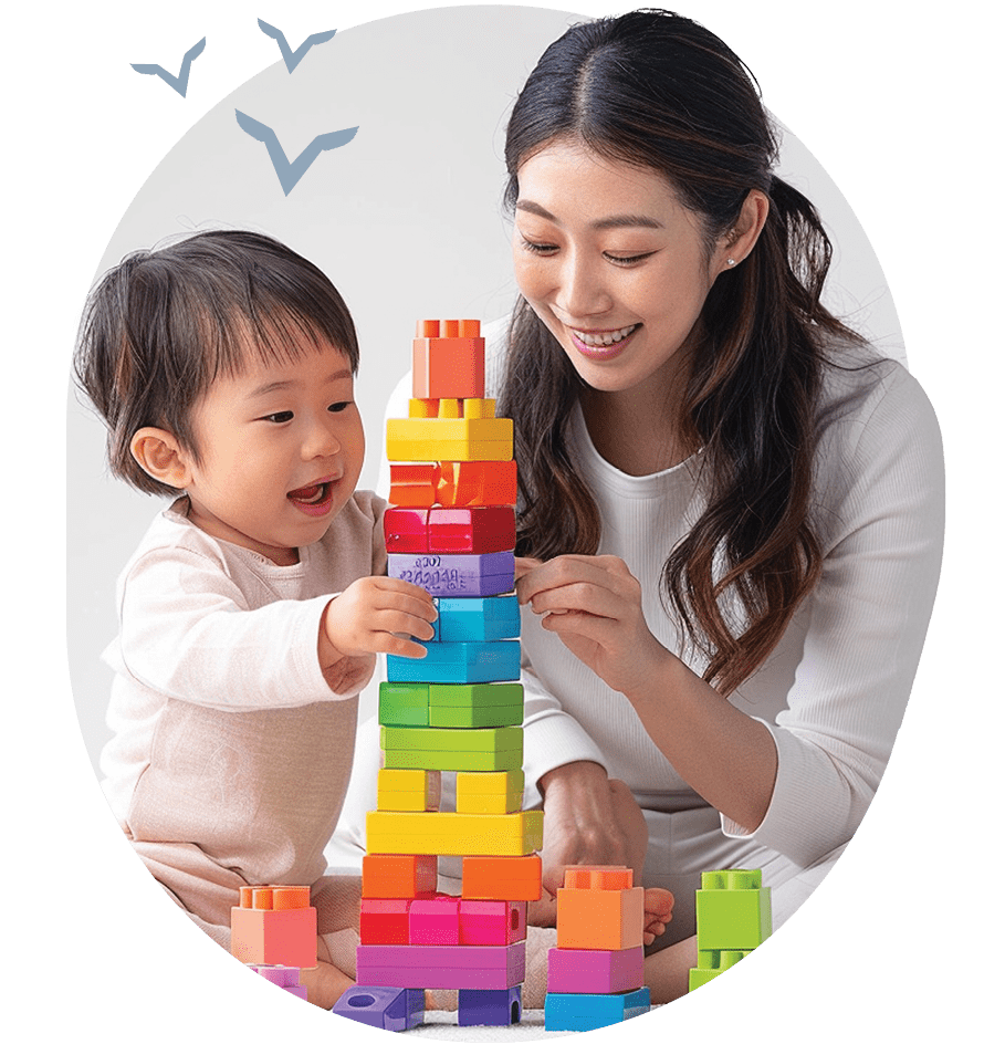 asian woman playing blocks with baby