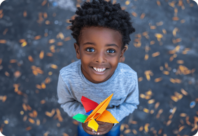 african boy holding paper plane