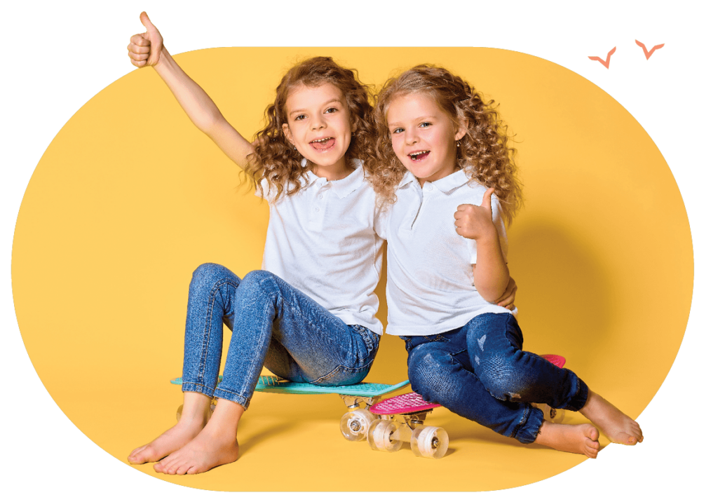 two girls sitting on skateboard