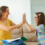 child and mother high five