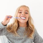 cute girl brushing her teeth