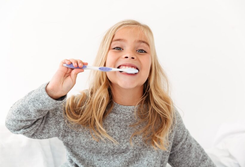 cute girl brushing her teeth