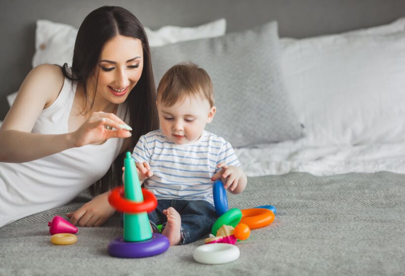 ypung mother playing blocks with her baby
